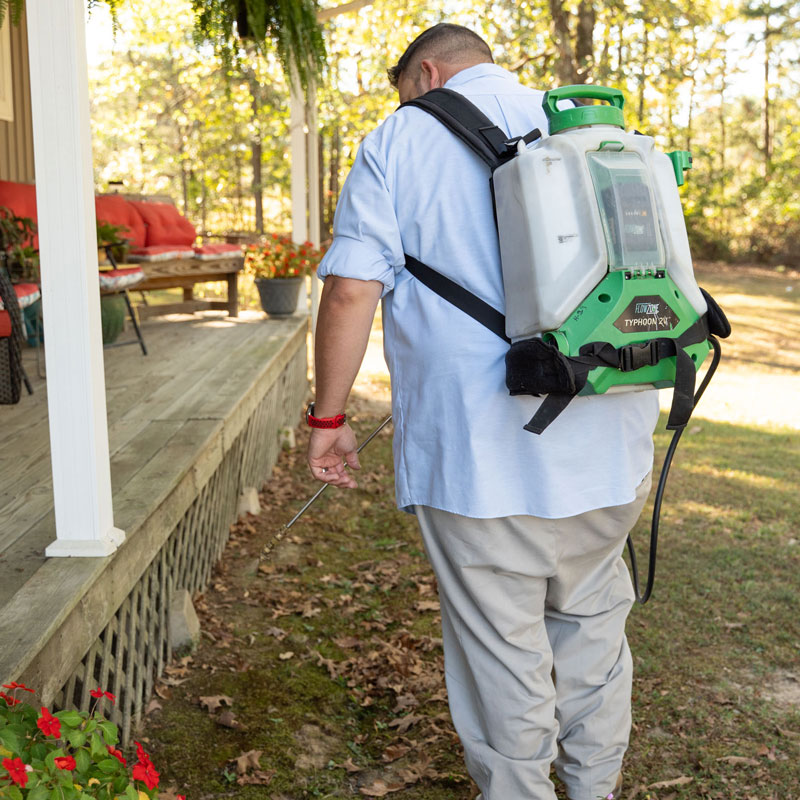 Hopper Technician Spraying Porch